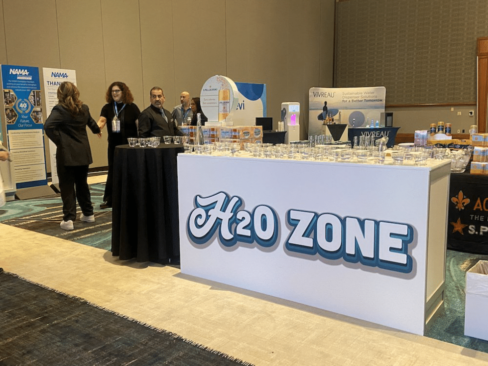 H2O Zone showcasing Vivreau’s sustainable water solutions at a Vegas event with attendees exploring hydration innovations