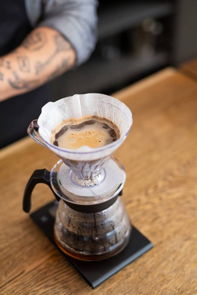 Brewing coffee with filtered water using a pour-over method