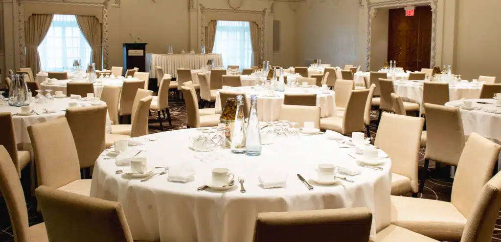 Elegant hotel banquet hall setup with Vivreau water bottles on the tables