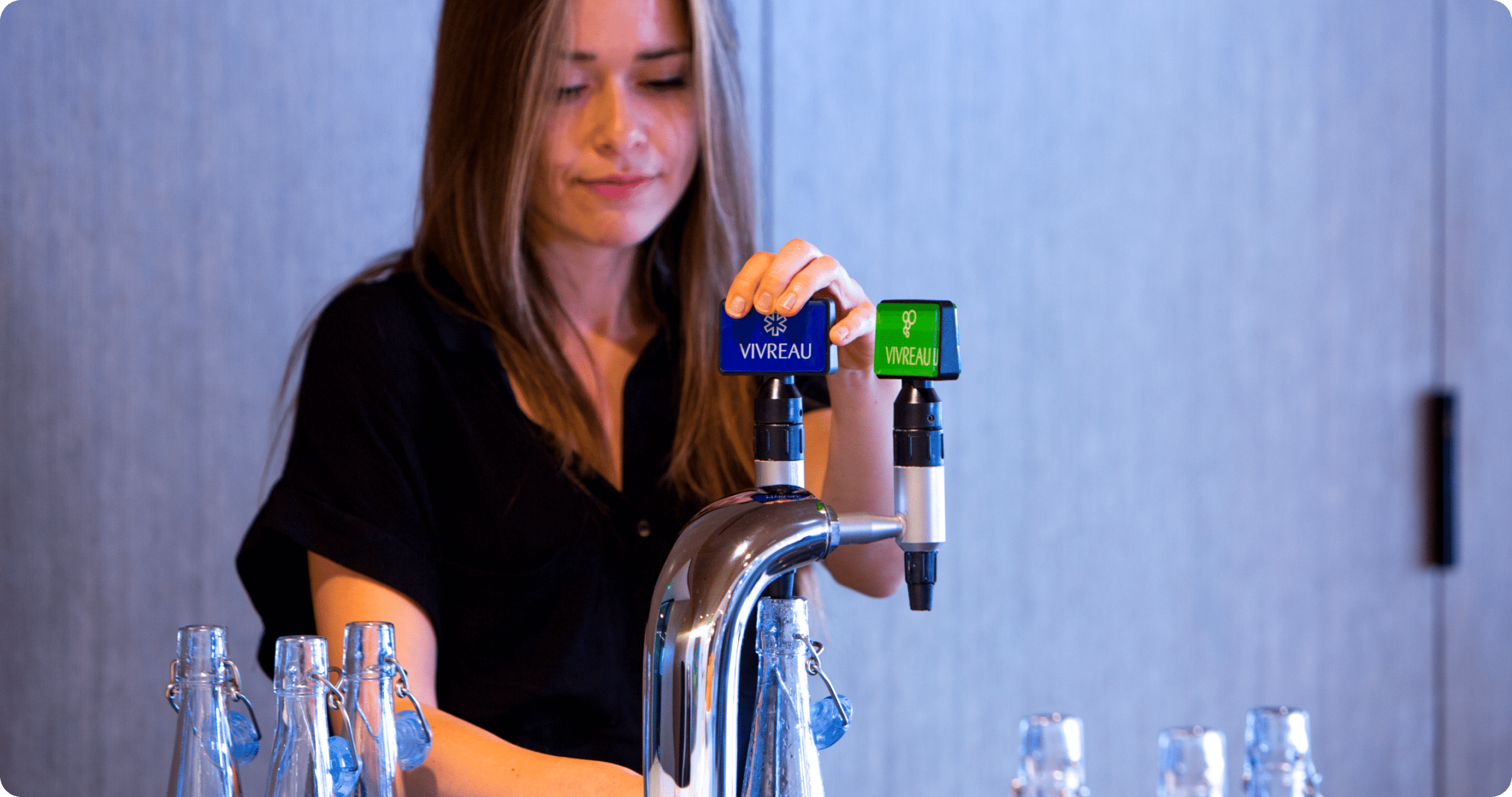 Person using water dispenser in office environment