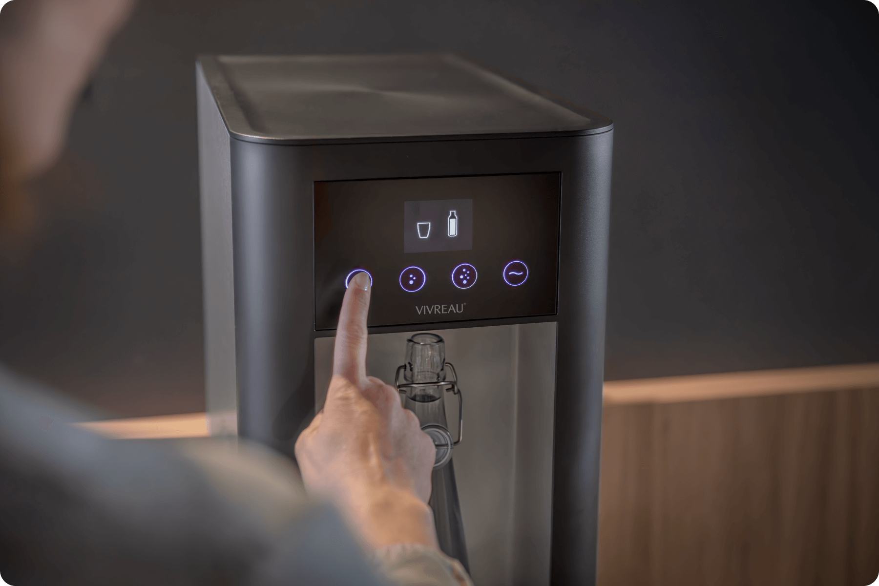 Person using water dispenser in office environment