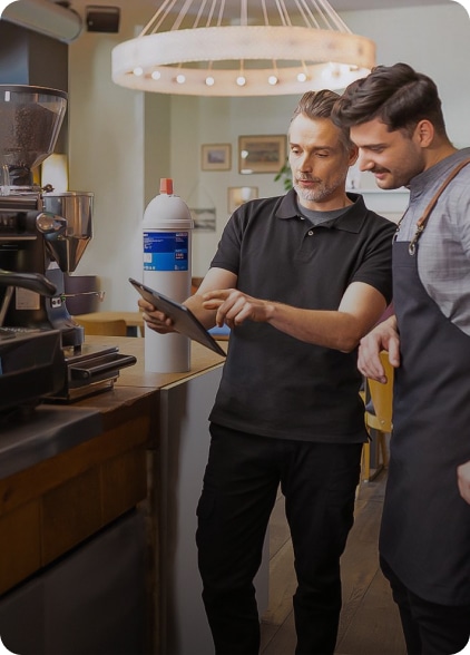 two men looking into tablet