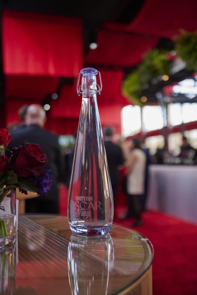 Vanity Fair Oscars 2024 Vivreau water bottle on a glass table at the red carpet event