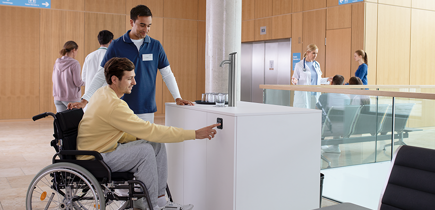 wheelchair user dispenses water